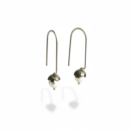 Boucles dormeuses tiges droites en argent forgé et patiné, serties de perles de culture ovales blanches. 